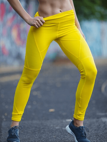 strong-female-legs-yellow-sporting-leggings_257482-119